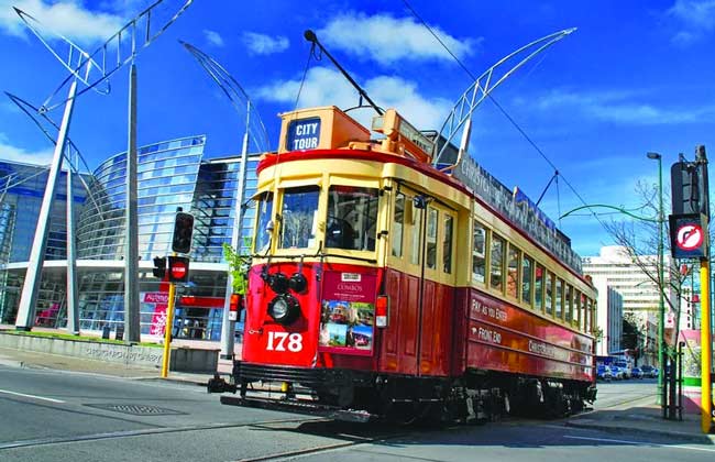 A tram driving through Christchurch City.