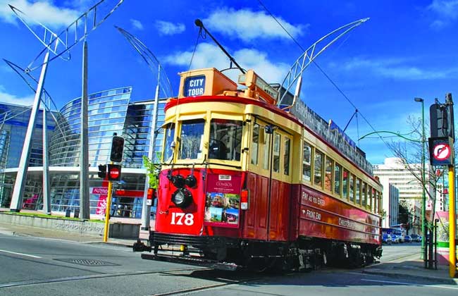 A tram driving through the city centre of Christchurch.