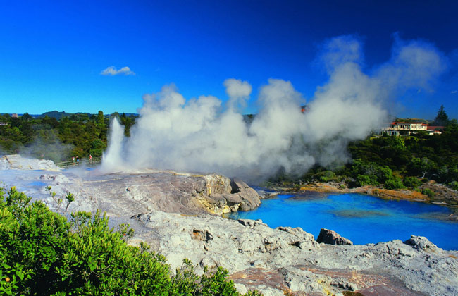 Fumes rising into the blue sky from the Thermal Wonderland's blue pools.
