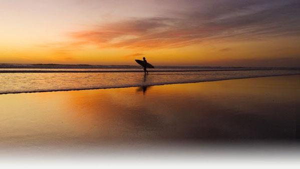 Surfing sunset New Zealand