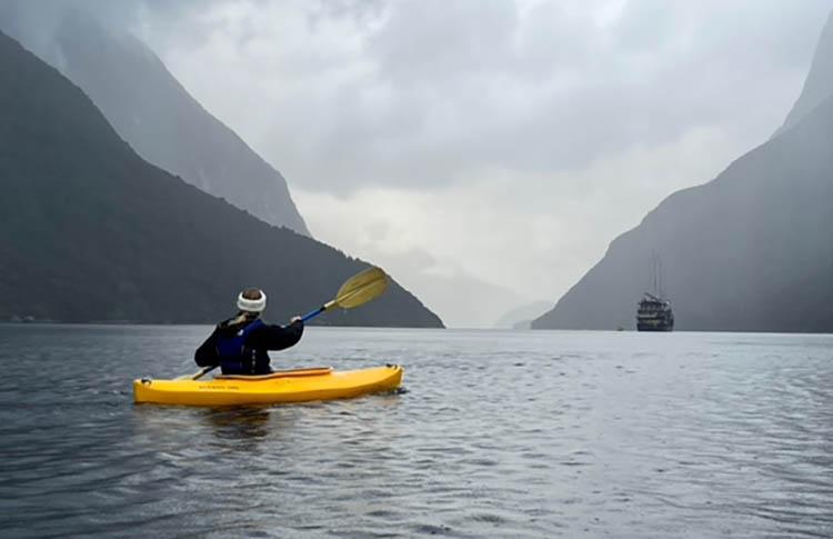 Person in yellow kayak in Doubtful Sound