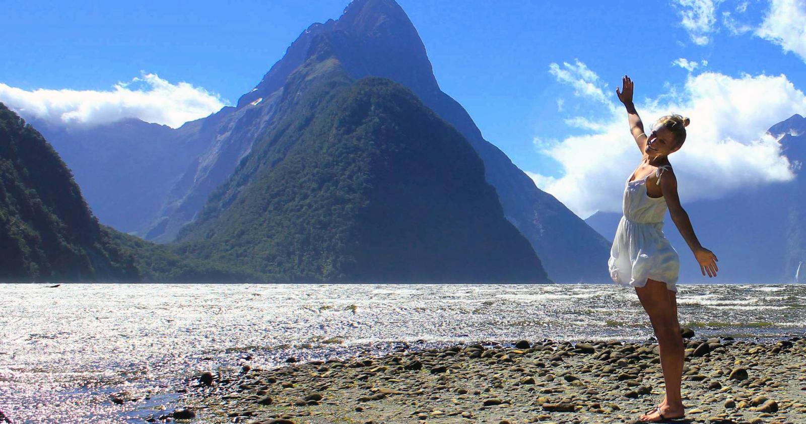 Woman rejoicing at the natural beauty of Milford Sound