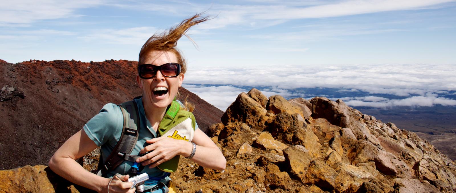 Girl summiting Mount Tongariro and screaming with joy.