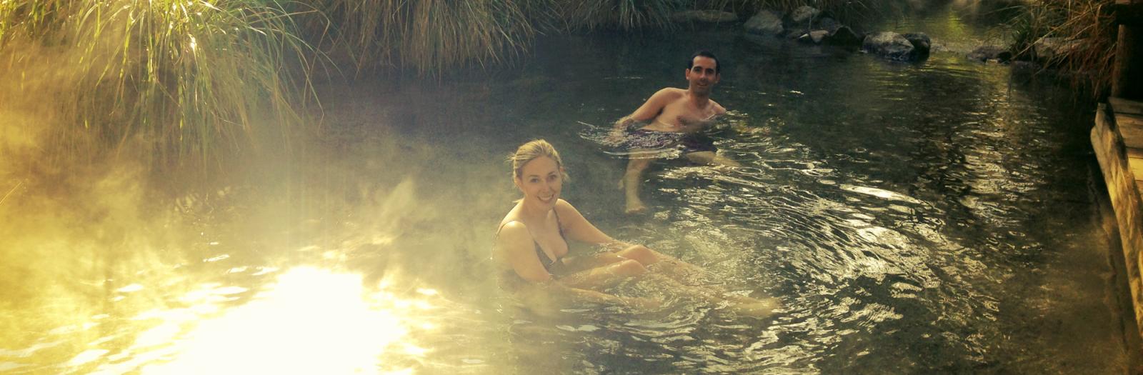 Couple soaking in New Zealand's Natural Hotpools.