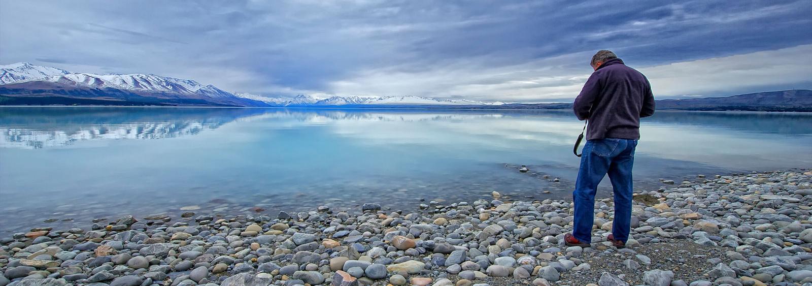 Photographer framing one of the glacier fed lakes in Central Oatago.