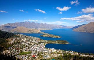 Aerial view of Queenstown with Lake Wakatipu and Remarkable Mountains in distance