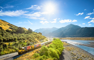 TranzAlpine train travelling alongside Waimakariri River