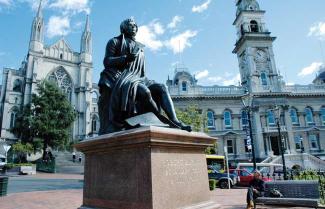 Dunedin City with a statue of Robbie Burns ot front.